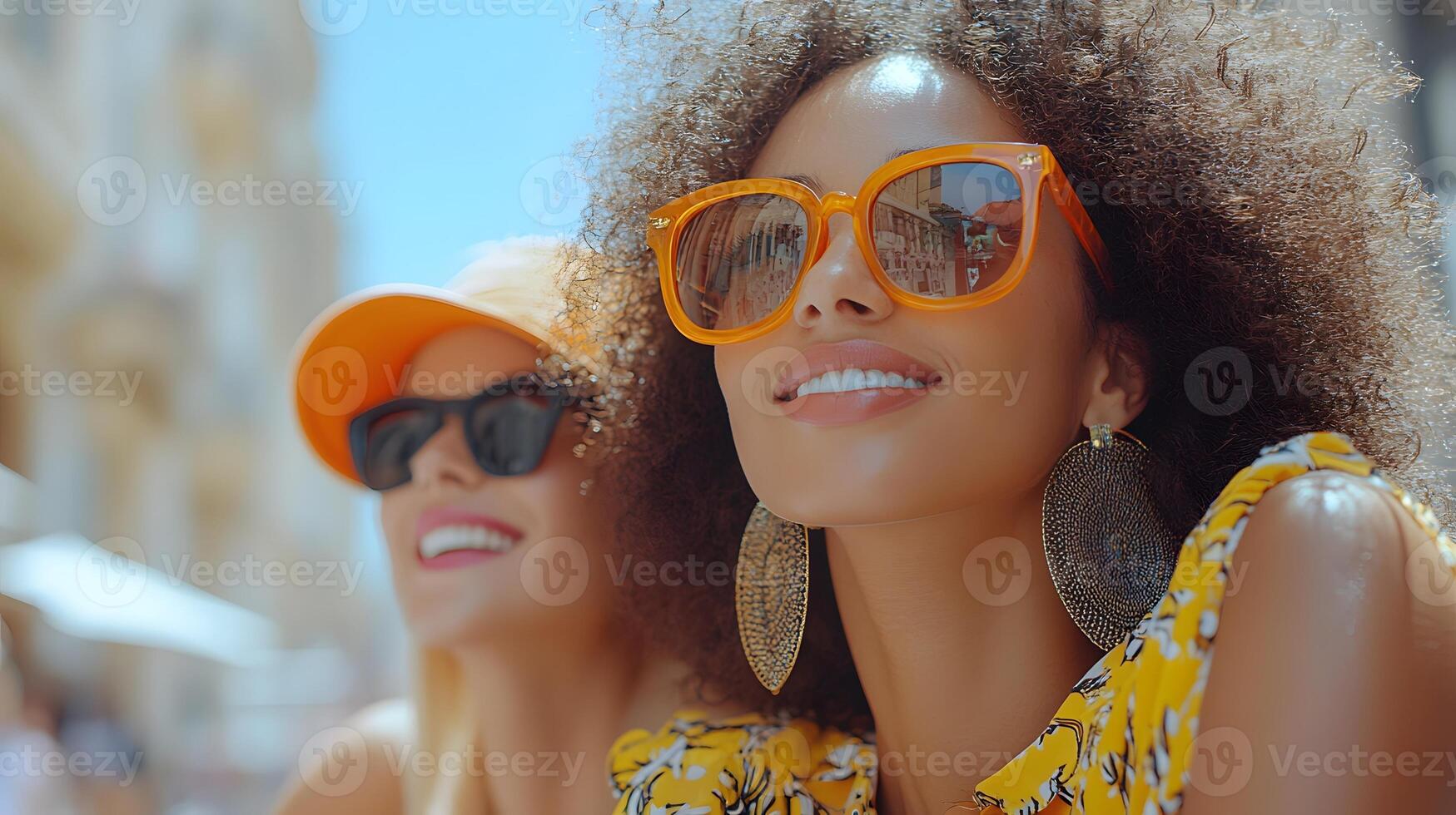 Female friends sitting together, leaning in with happy expressions, viewing phone content photo