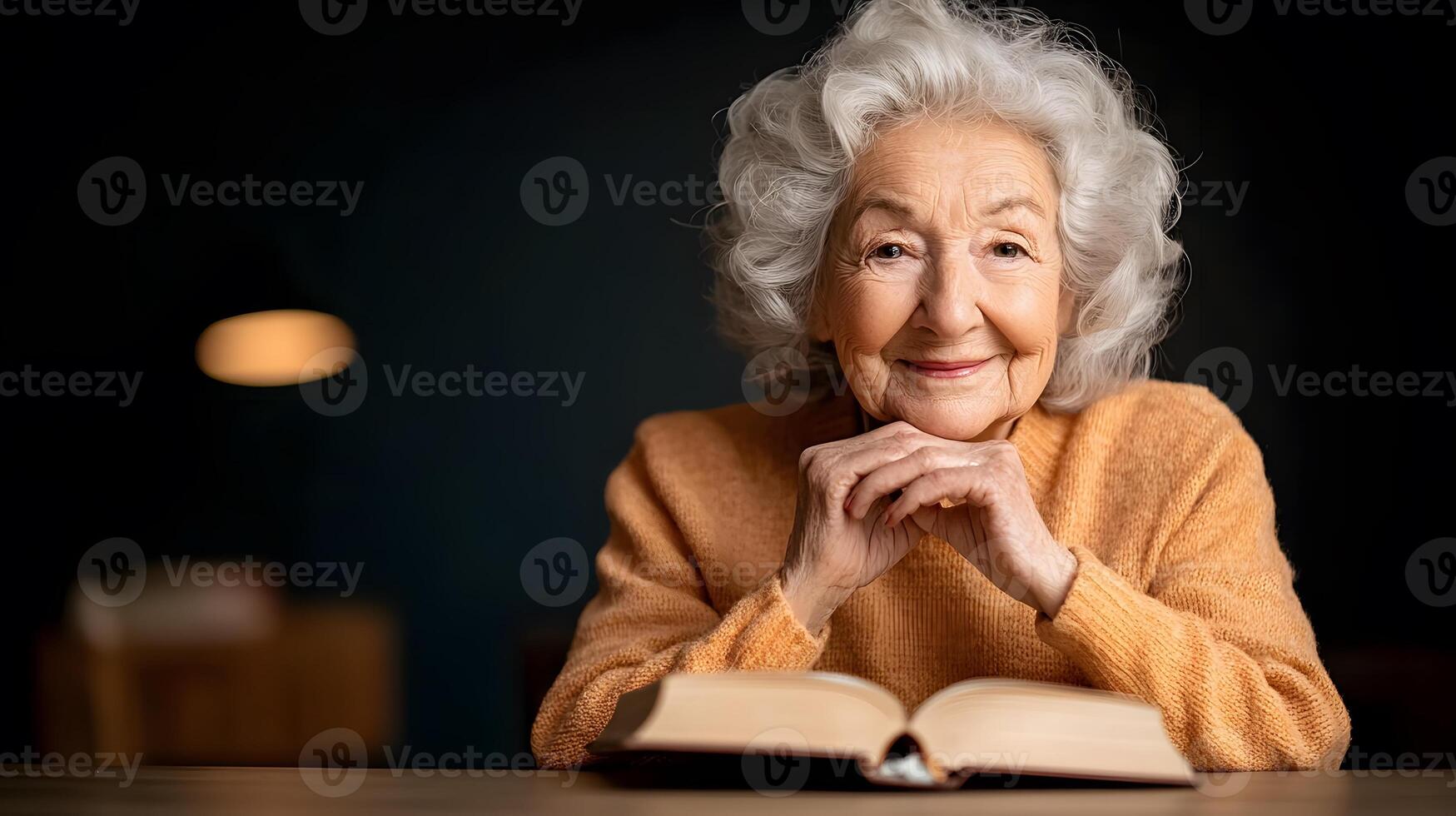Senior woman reading a book in a cozy library with a bright smile photo