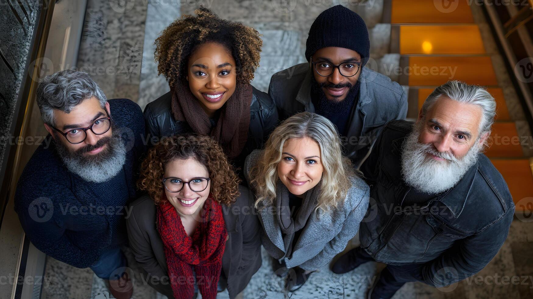 Group of employees standing together in office lobby, showing support and unity for workplace goals photo