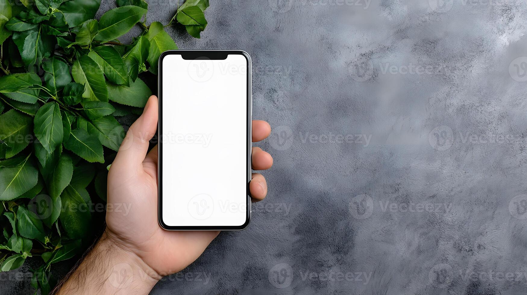 Minimal smartphone with a blank screen held vertically in a workspace, ready for branding purposes photo