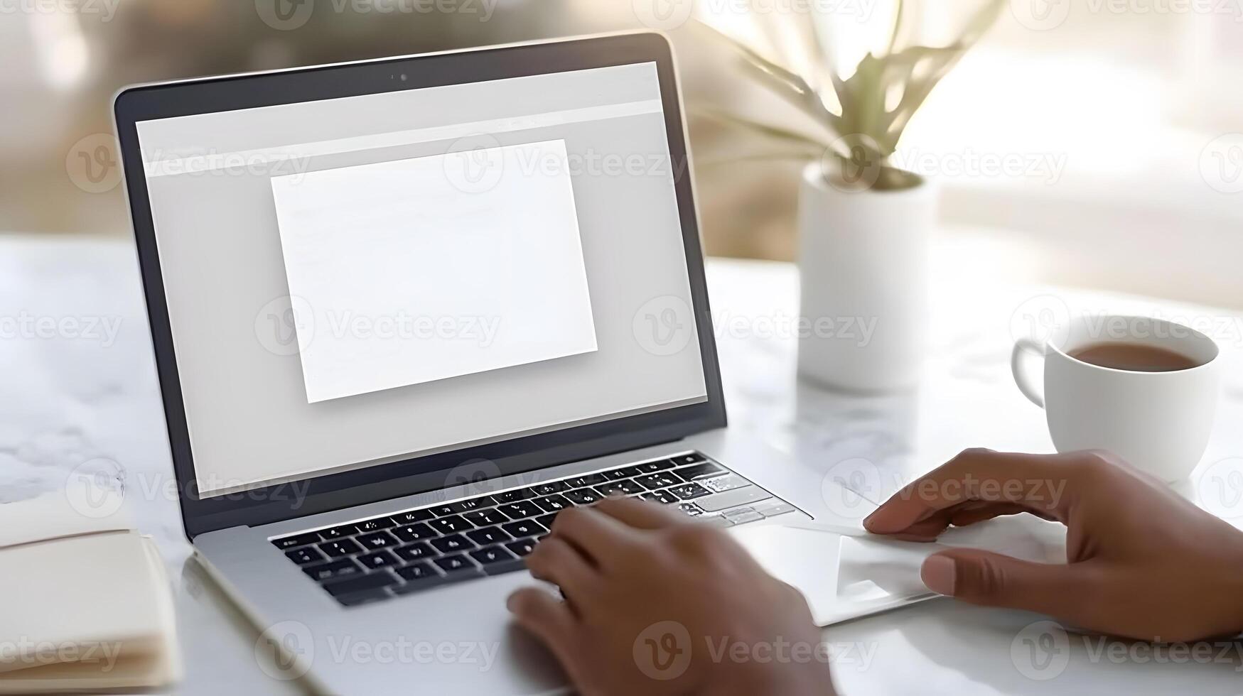 Employee opening a laptop displaying New Year resolutions and inspirational quotes photo