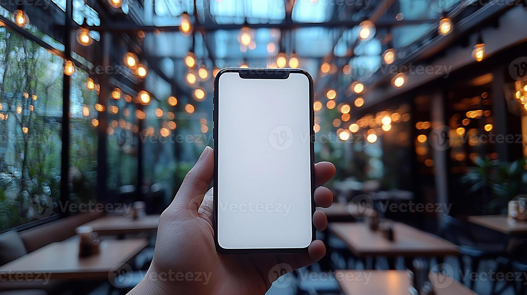 Realistic hand holding a smartphone mockup with blank white screen, blurred cafe background, soft lighting, 3D rendering photo