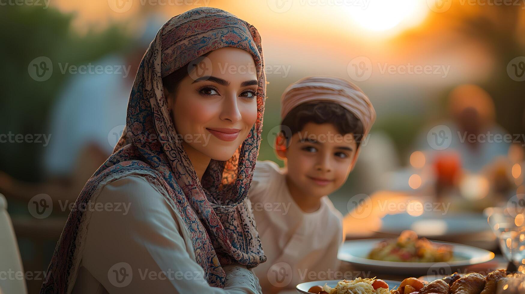 Family gathered around a table enjoying Iftar meal during sunset with traditional dishes, photo