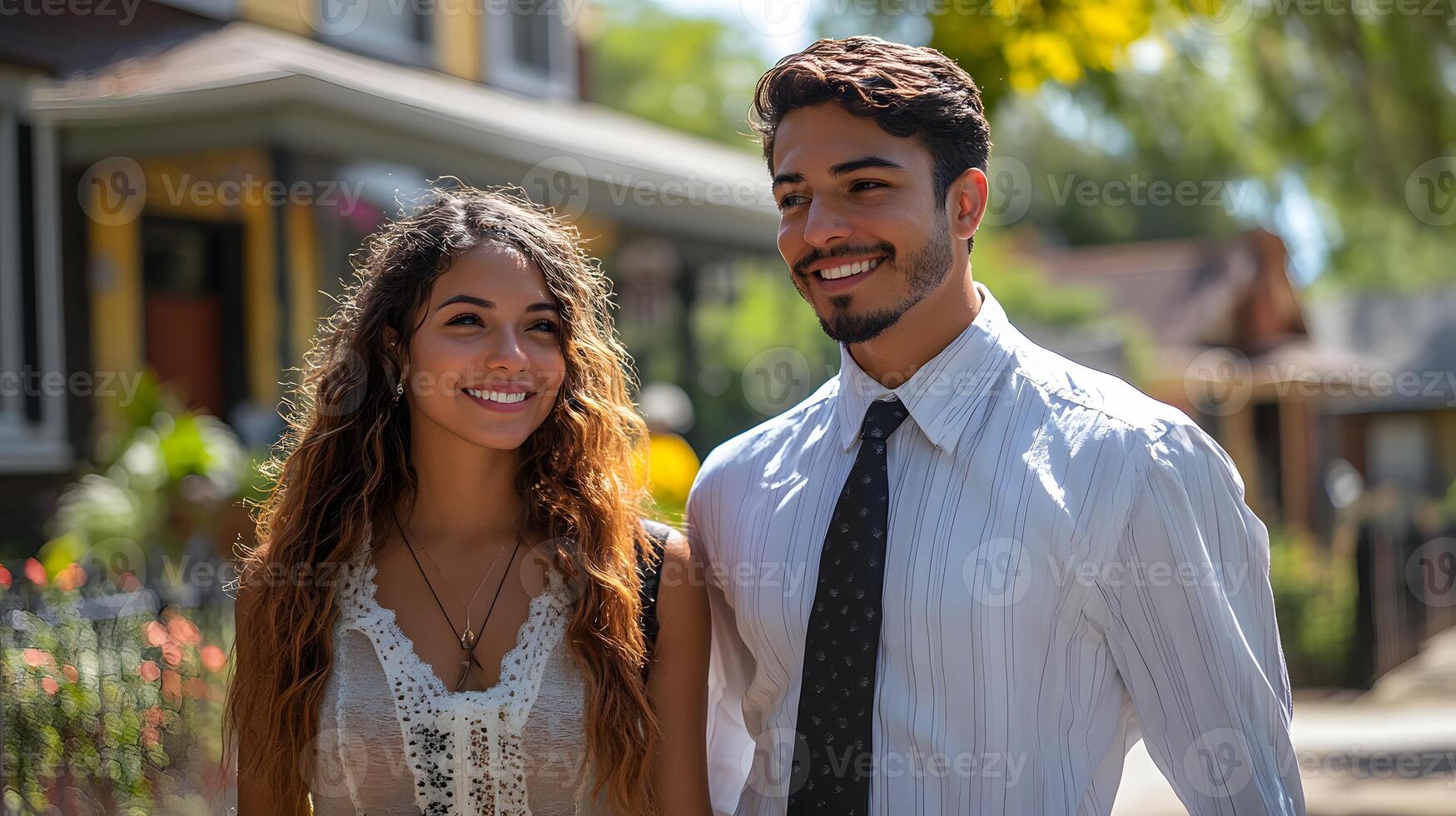 Young couple with a realtor walking near fences and enjoying a well-kept suburban neighborhood, photo