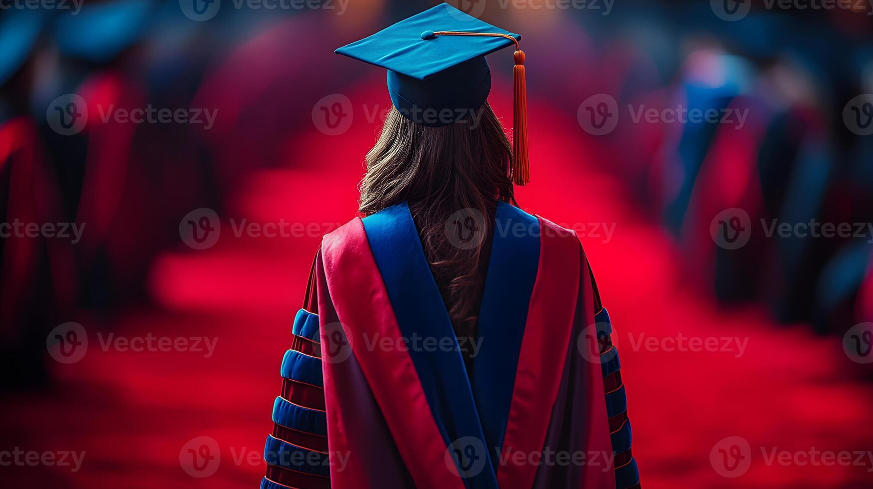 Graduate walking across a stage, audience in soft focus with copy space photo