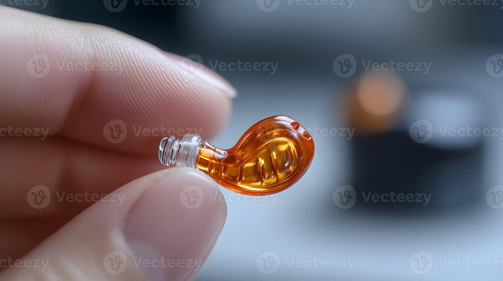 A person inserting a hearing aid, with clear focus on the device and a blurred background that emphasizes the action. photo