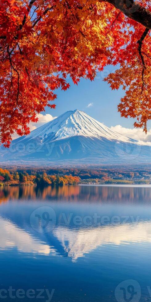 Majestic mountain reflection in serene lake surrounded by vibrant autumn foliage. clear blue sky enhances beauty of this tranquil landscape photo