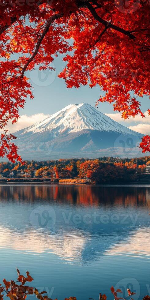 Majestic Mount Fuji reflected in serene lake, surrounded by vibrant autumn foliage. scene captures beauty of nature and tranquility photo
