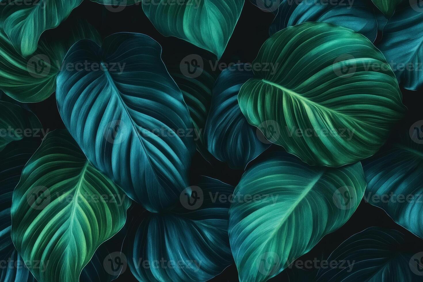 Lush green leaves with intricate textures create vibrant background, showcasing various shades of green and blue. This natural design evokes sense of tranquility and freshness photo