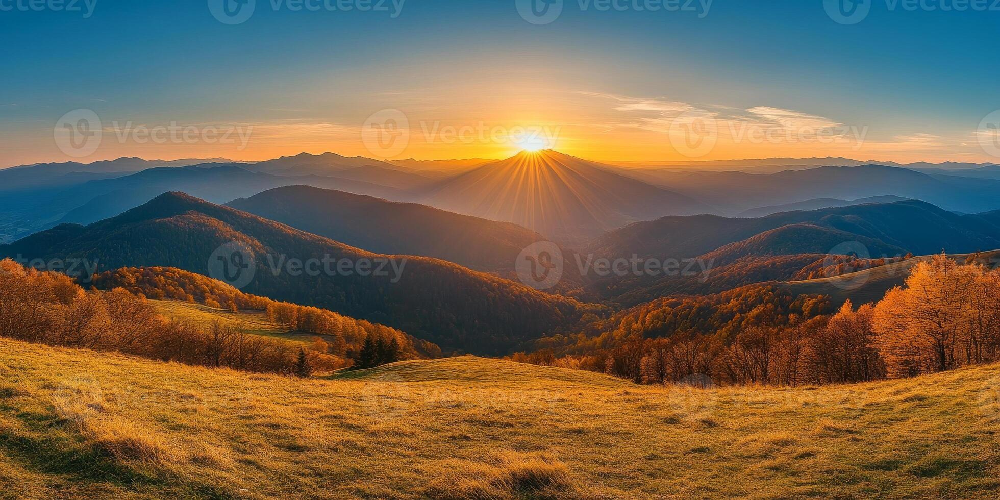 breathtaking sunset over rolling hills, casting golden rays across landscape, with vibrant autumn foliage and distant mountains creating serene atmosphere photo