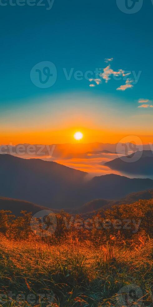 breathtaking sunset over rolling mountains, casting warm hues across landscape. serene atmosphere invites tranquility and reflection, showcasing nature beauty photo