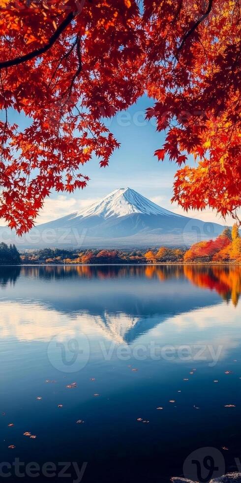 Majestic Mount Fuji reflected in serene lake, surrounded by vibrant autumn foliage. scene captures beauty of nature, evoking sense of tranquility and wonder photo