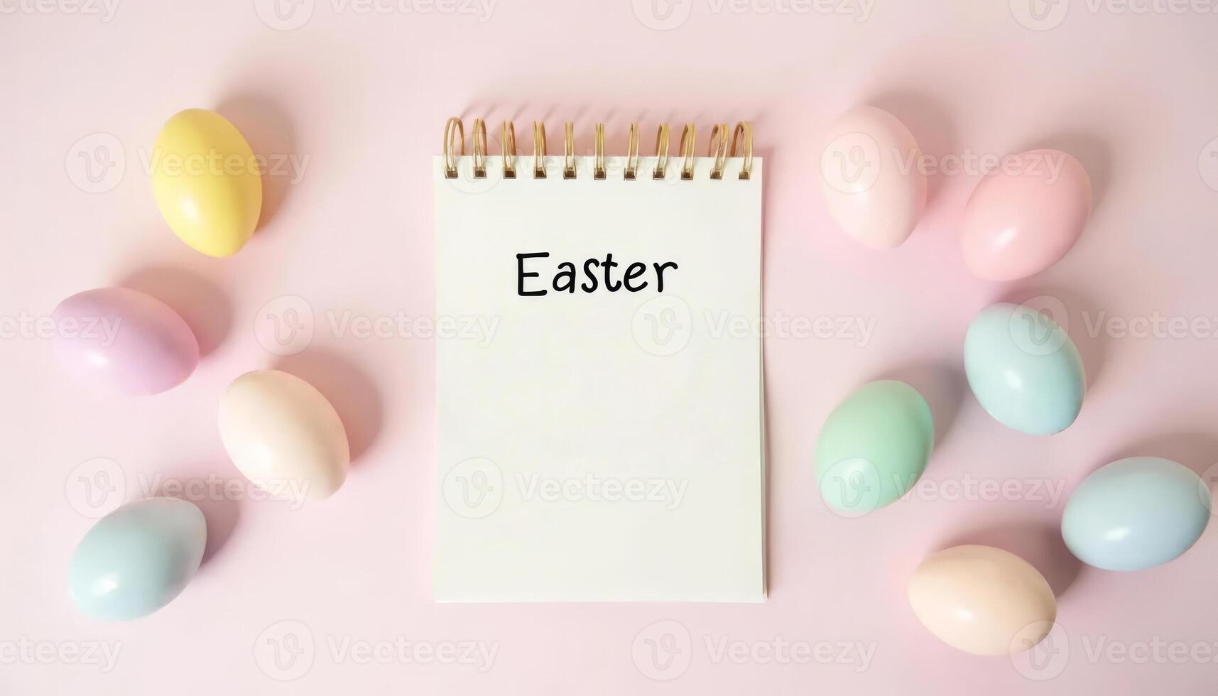 Spiral flip notebook with the inscription Easter with colorful eggs on a pastel background. photo
