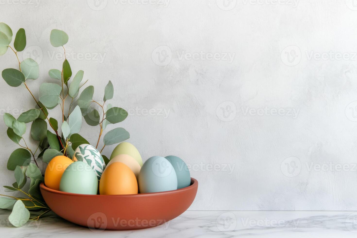 Creating a minimalist Easter centerpiece with simple colored Easter eggs on marble countertop featuring eucalyptus leaves for a fresh, seasonal decoration idea photo