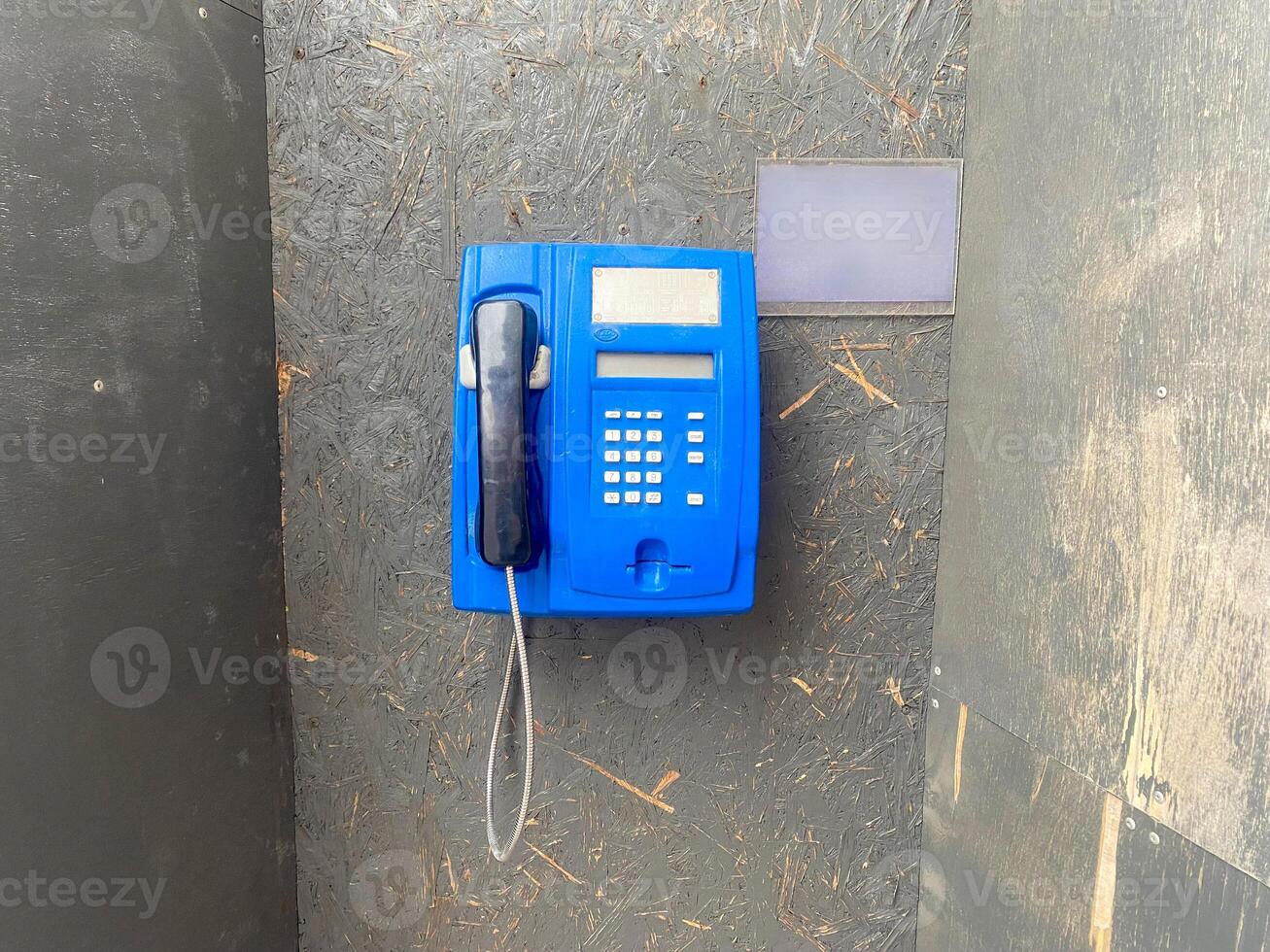 Phone booth for talking on the phone in the street, phone on the wire photo