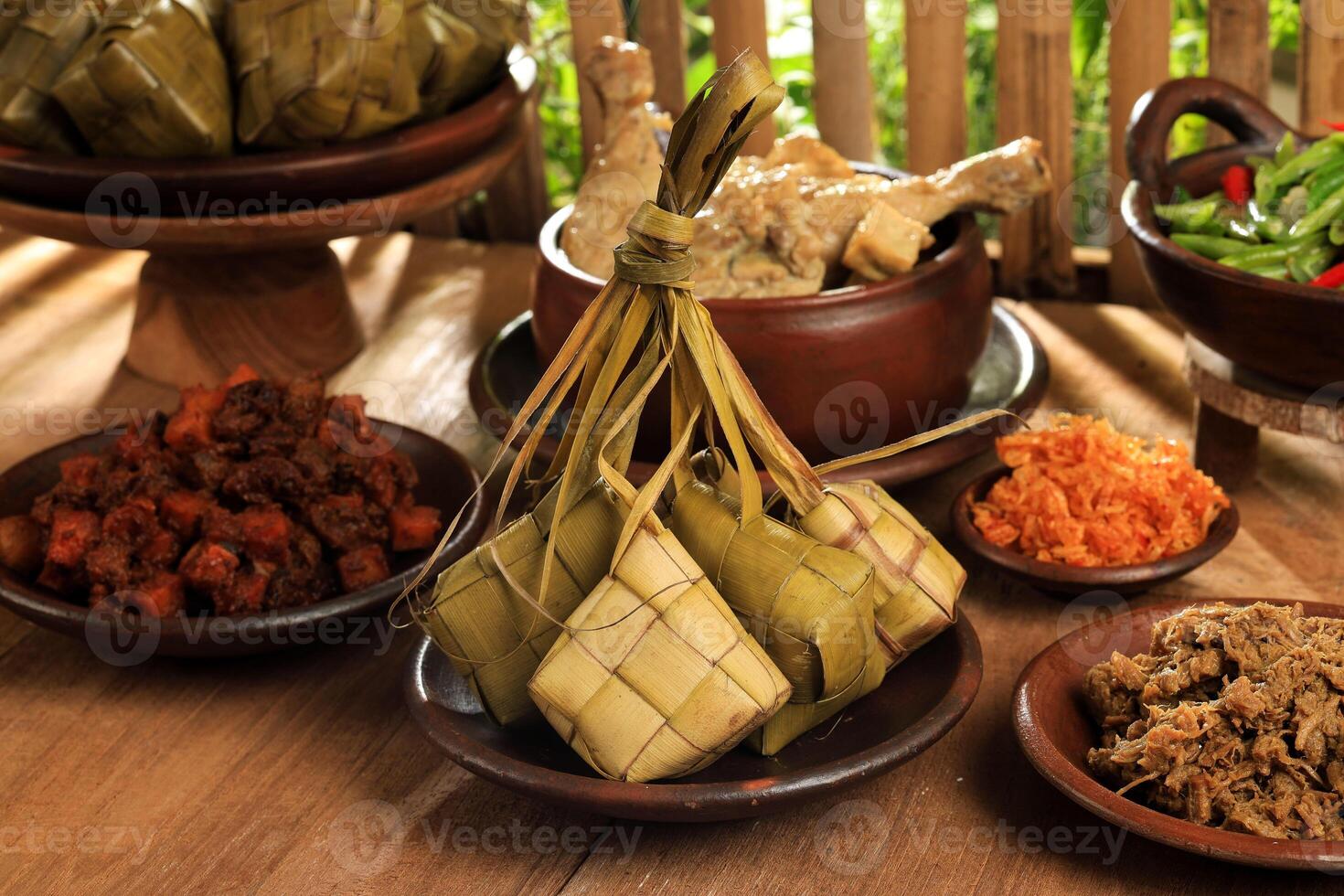 Ketupat Lebaran and Various Side Dish on the Table. Eid al Fitr Menu photo