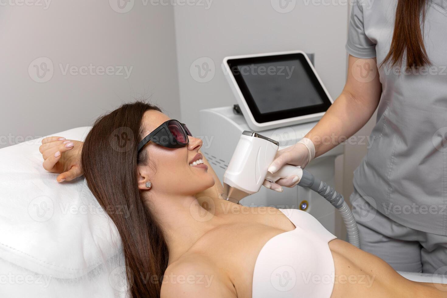 Laser hair removal session at a modern beauty clinic featuring a relaxed client photo