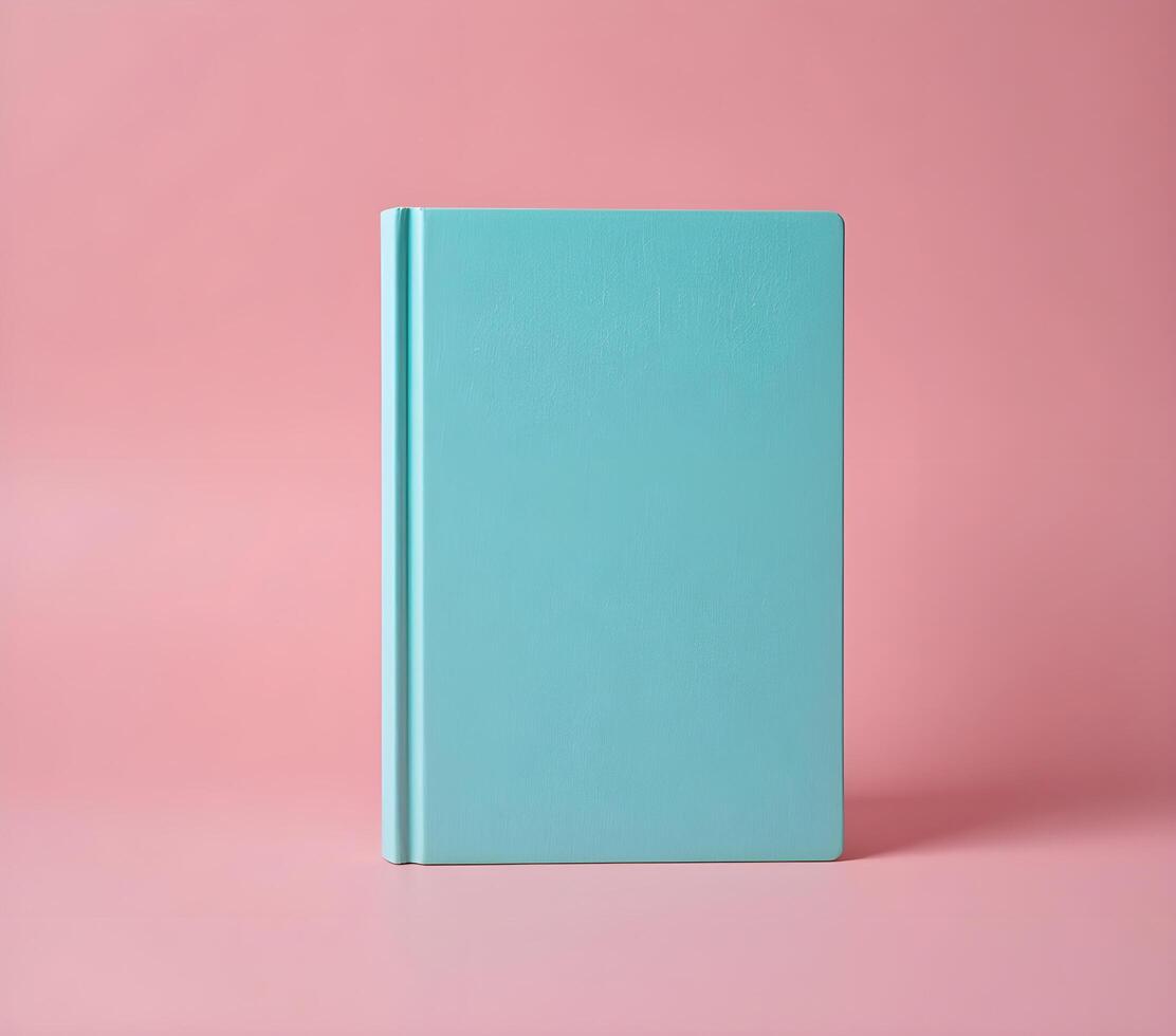 Mint Green Book Against a Pink Background, Ideal for Stationery Design photo