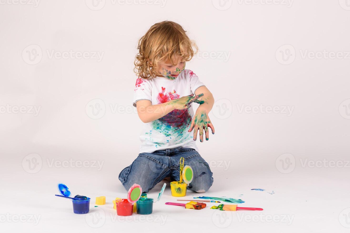Boy covered with colorful paints photo