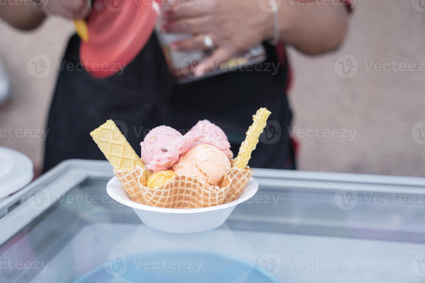 An Hispanic adult woman is preparing a traditional Mexican ice cream with cookies on a wafer photo
