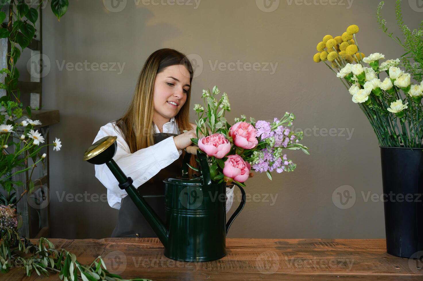 Female florist arranging flowers in shop photo