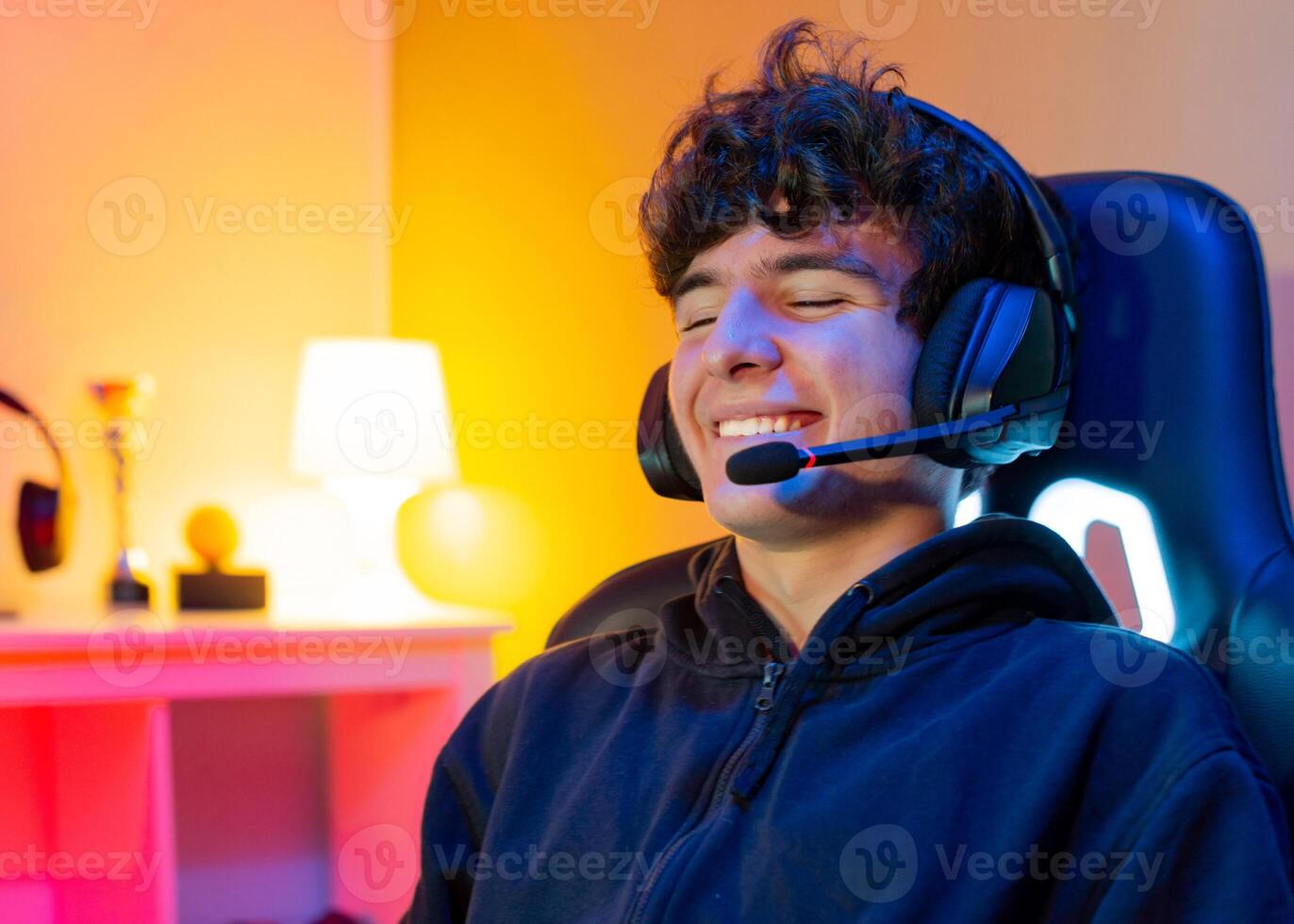 Cheerful gamer using headset with mic photo