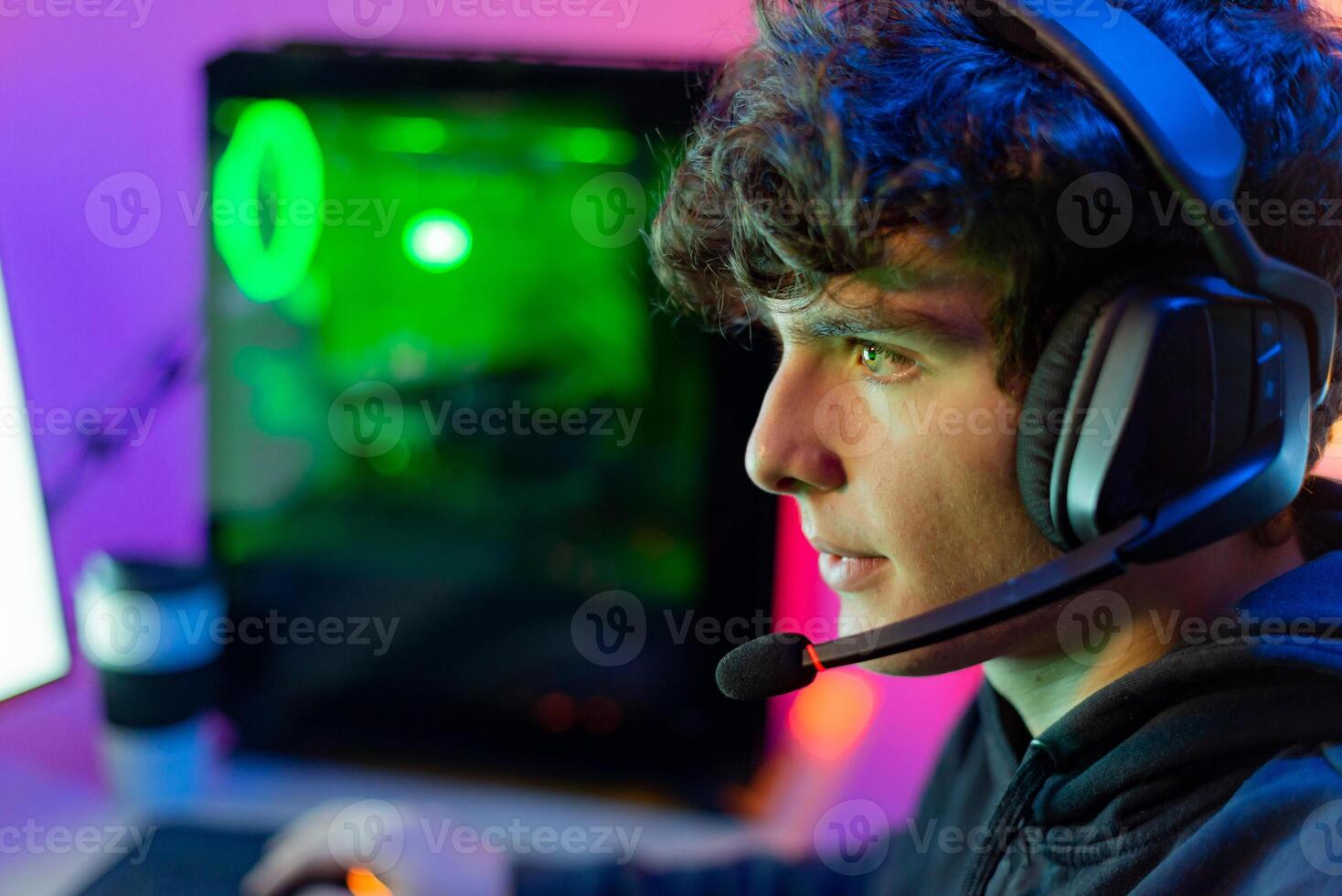 Man with gaming headset playing computer game photo
