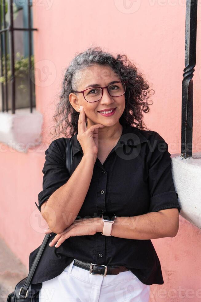 Portrait of an elegant businesswoman outdoors, looking at the camera. photo