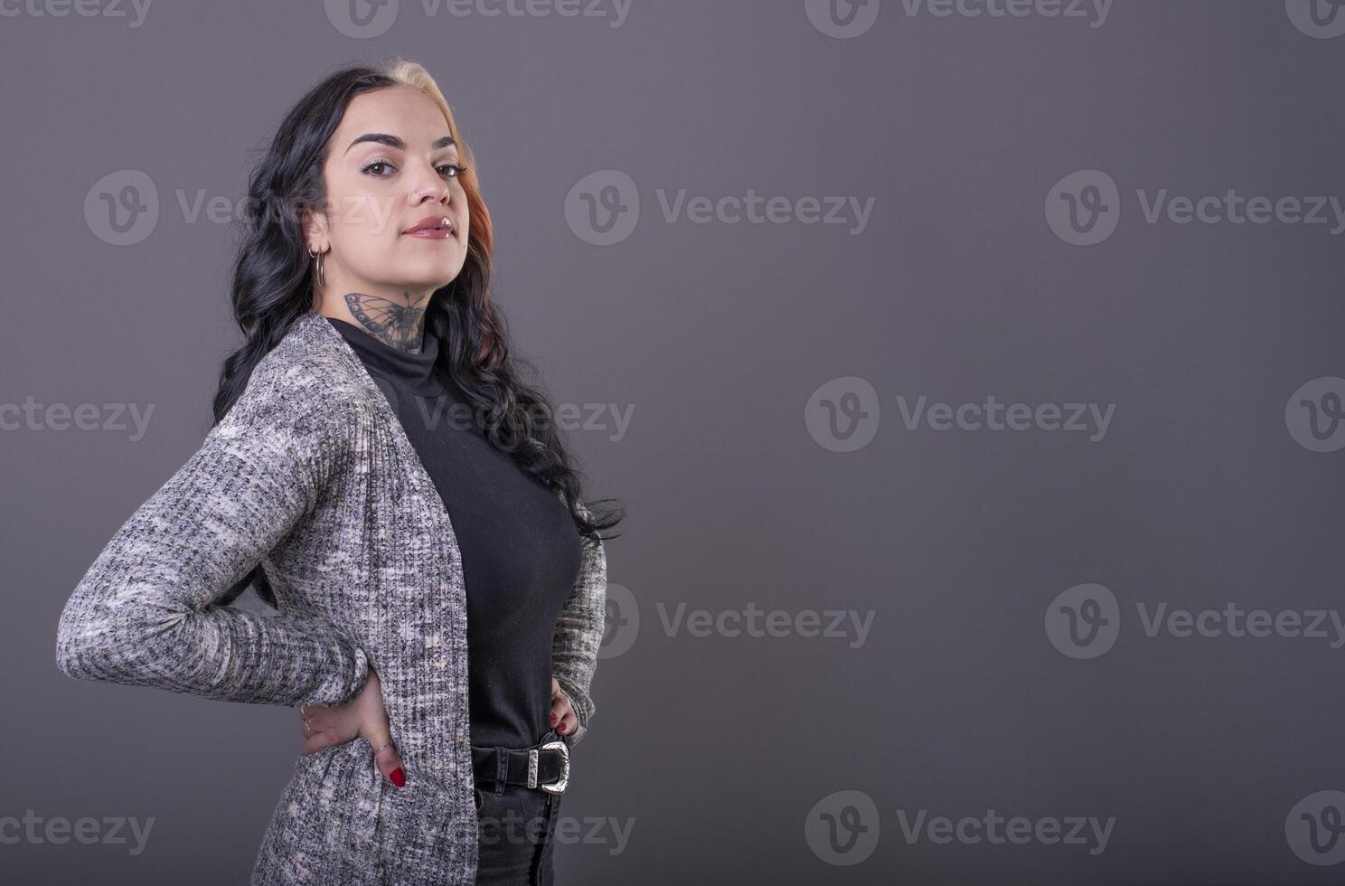 Beautiful woman posing with hands on waist. Copy Space photo
