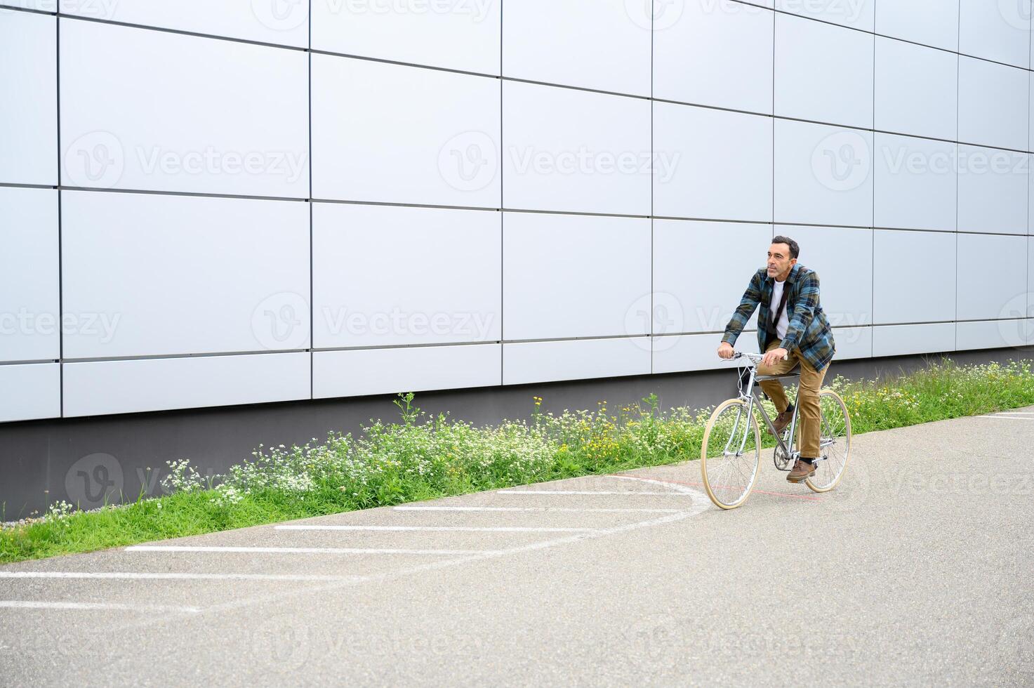 Smiling man with bicycle on road photo