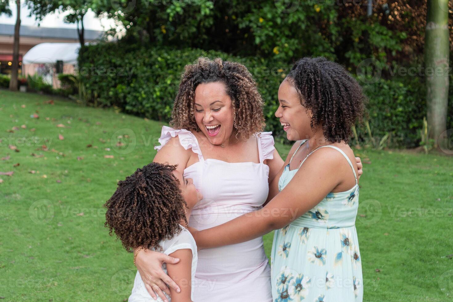 Latin American mother with her daughters smiling together. photo