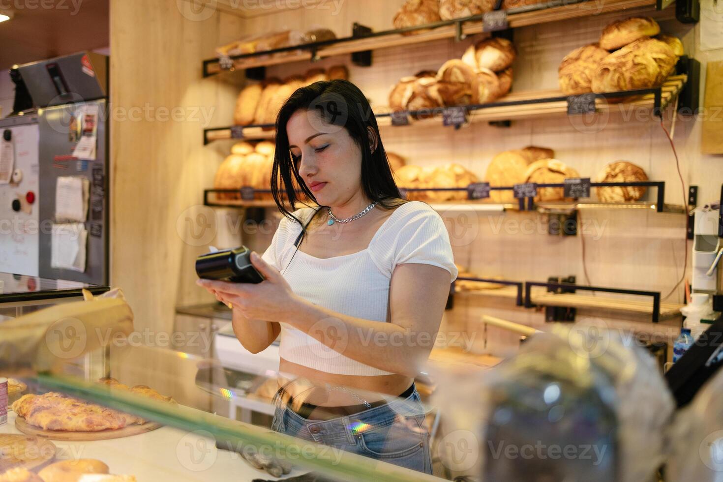 Sales clerk with dataphone in hand photo