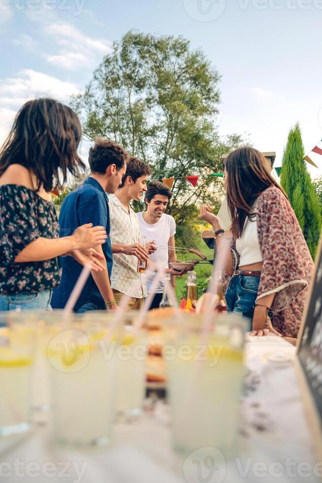 Group of friends having fun in a summer barbecue photo