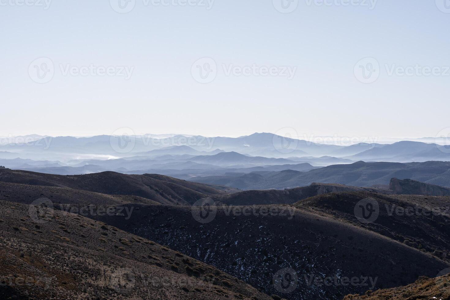 A landscape mountainous view with a lot of layers and deep of field and fog on the top photo