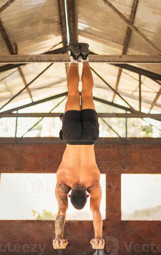 athletic man doing a vertical handstand photo