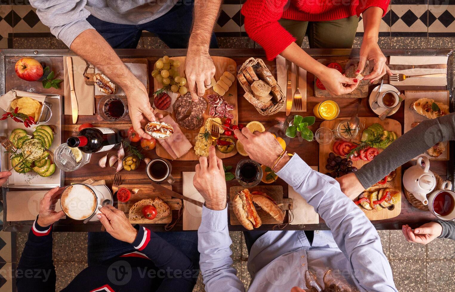 Anonymous friends having appetizers at table photo