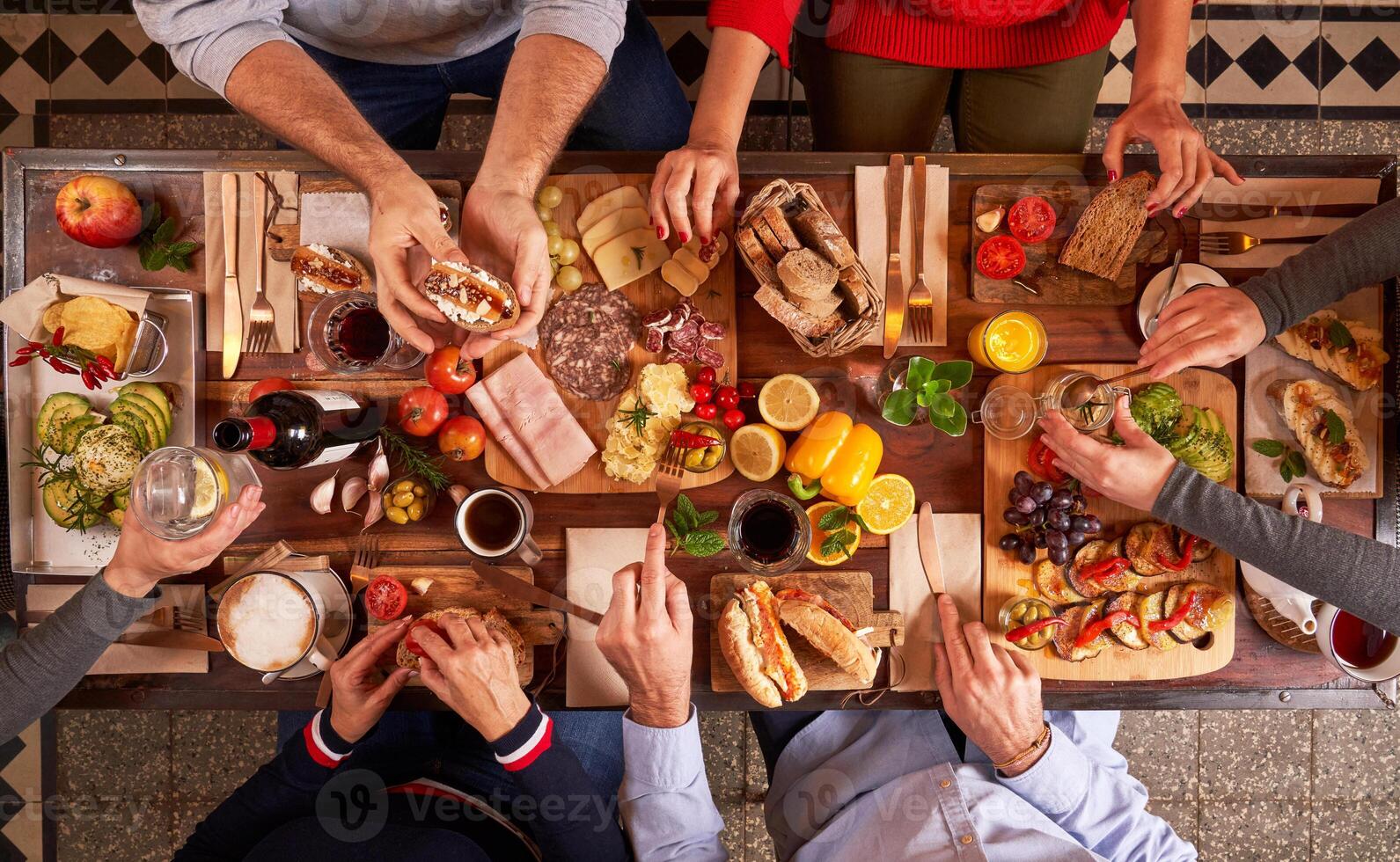 Unrecognizable people eating at served table photo
