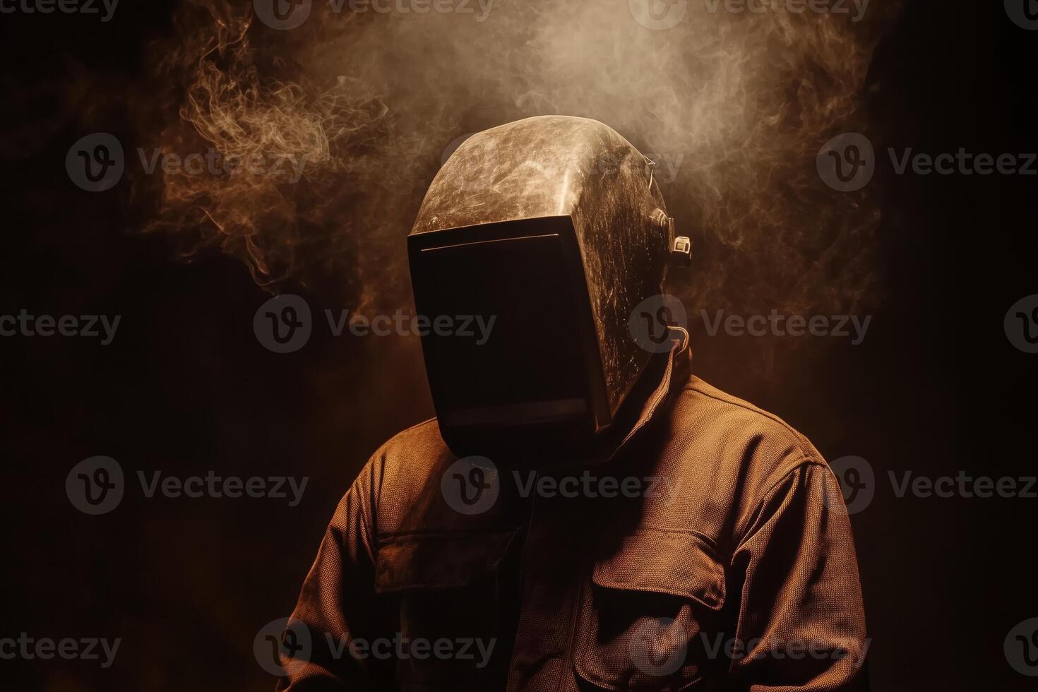 A man wearing a welding helmet and a dark background photo