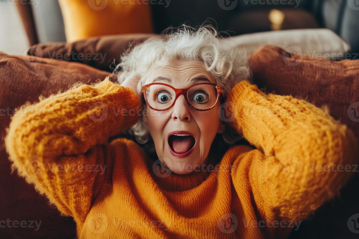 An older woman with glasses and an orange sweater is surprised photo