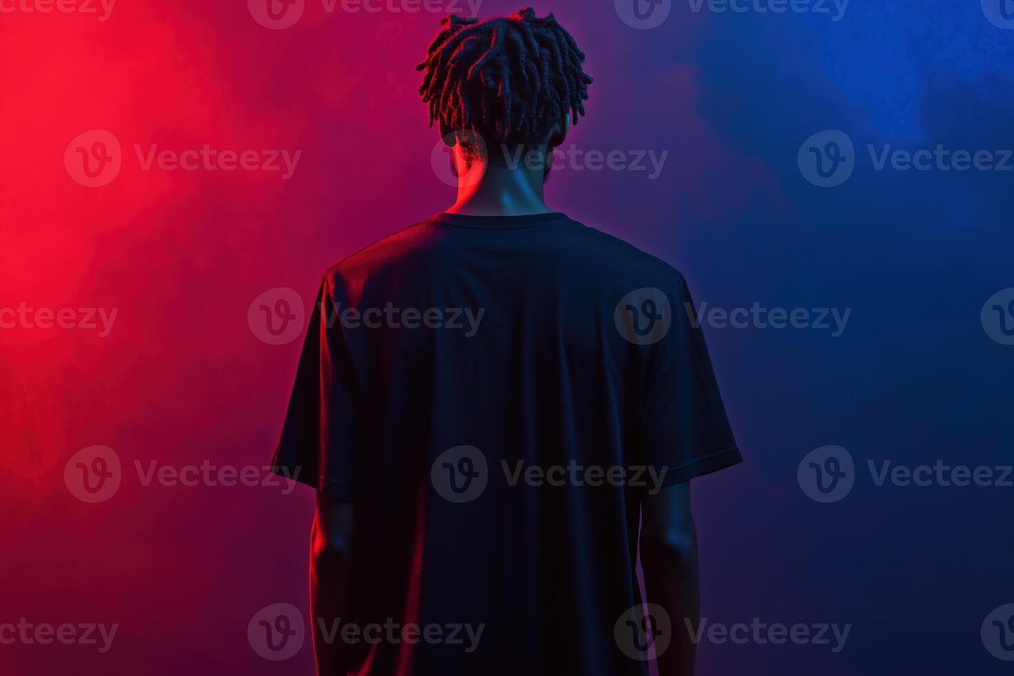 A man with dreadlocks standing in front of a red and blue smoke photo