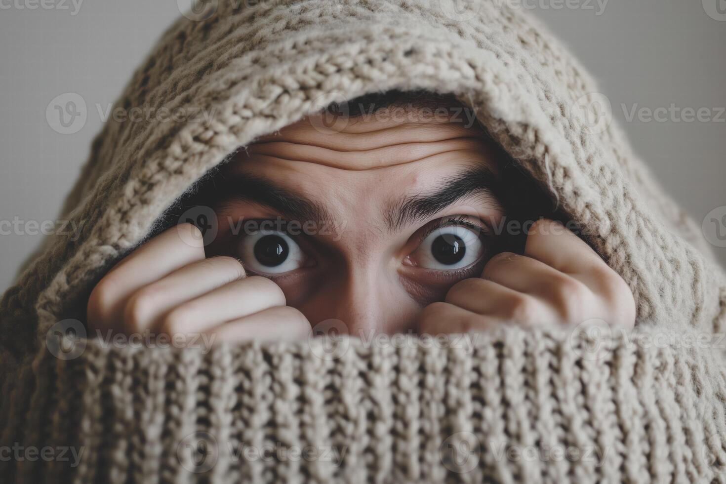 A person covered in a blanket with their eyes open photo