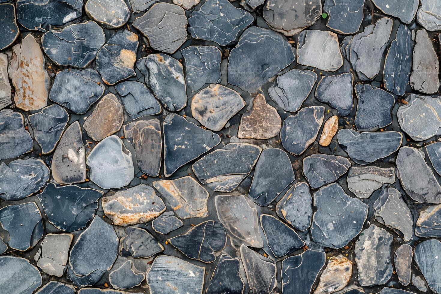 A close up of a stone wall with many different types of rocks photo