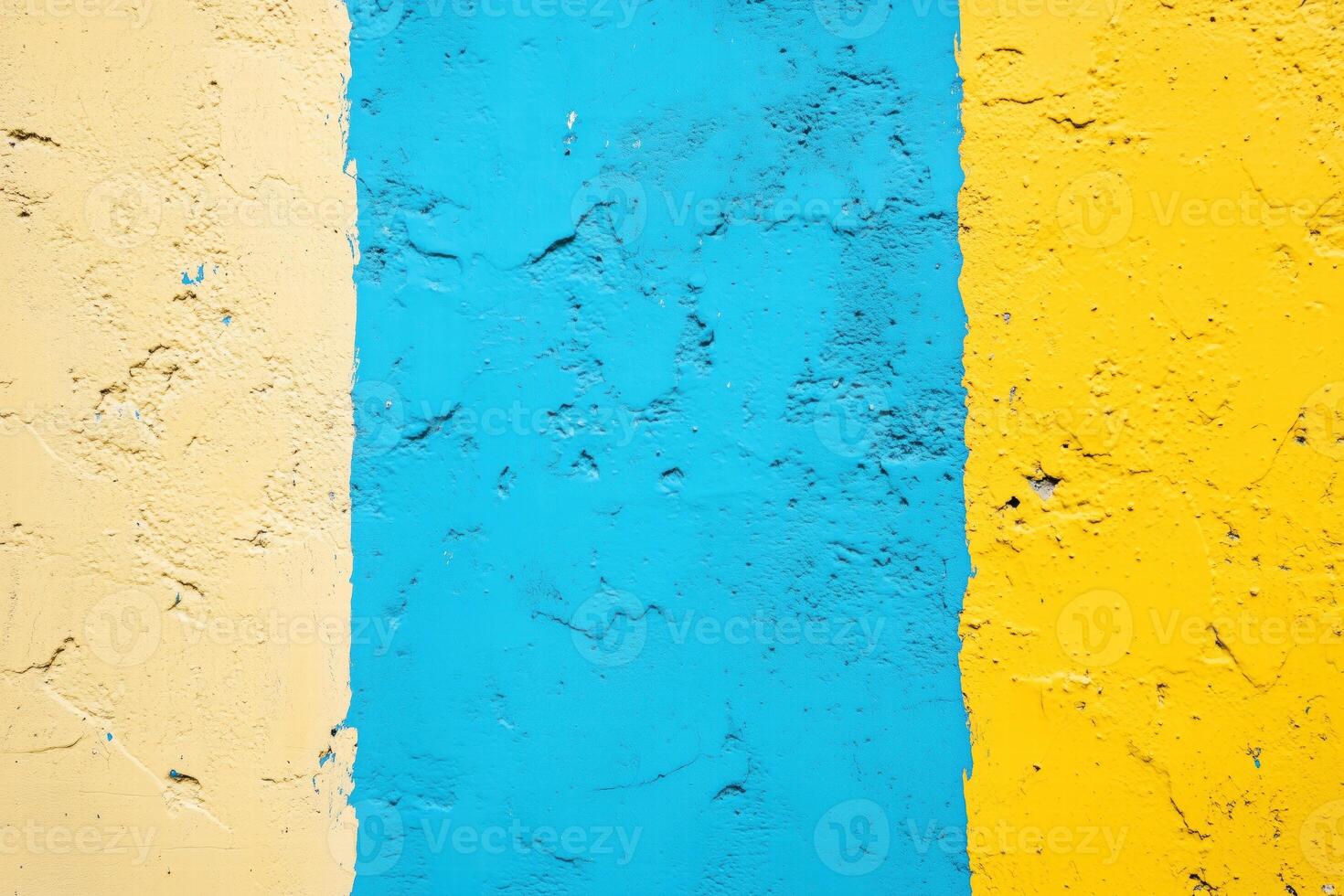 A vibrant wall featuring three vertical stripes in yellow, blue, and light blue. The textured surface adds depth and character to the colors. photo