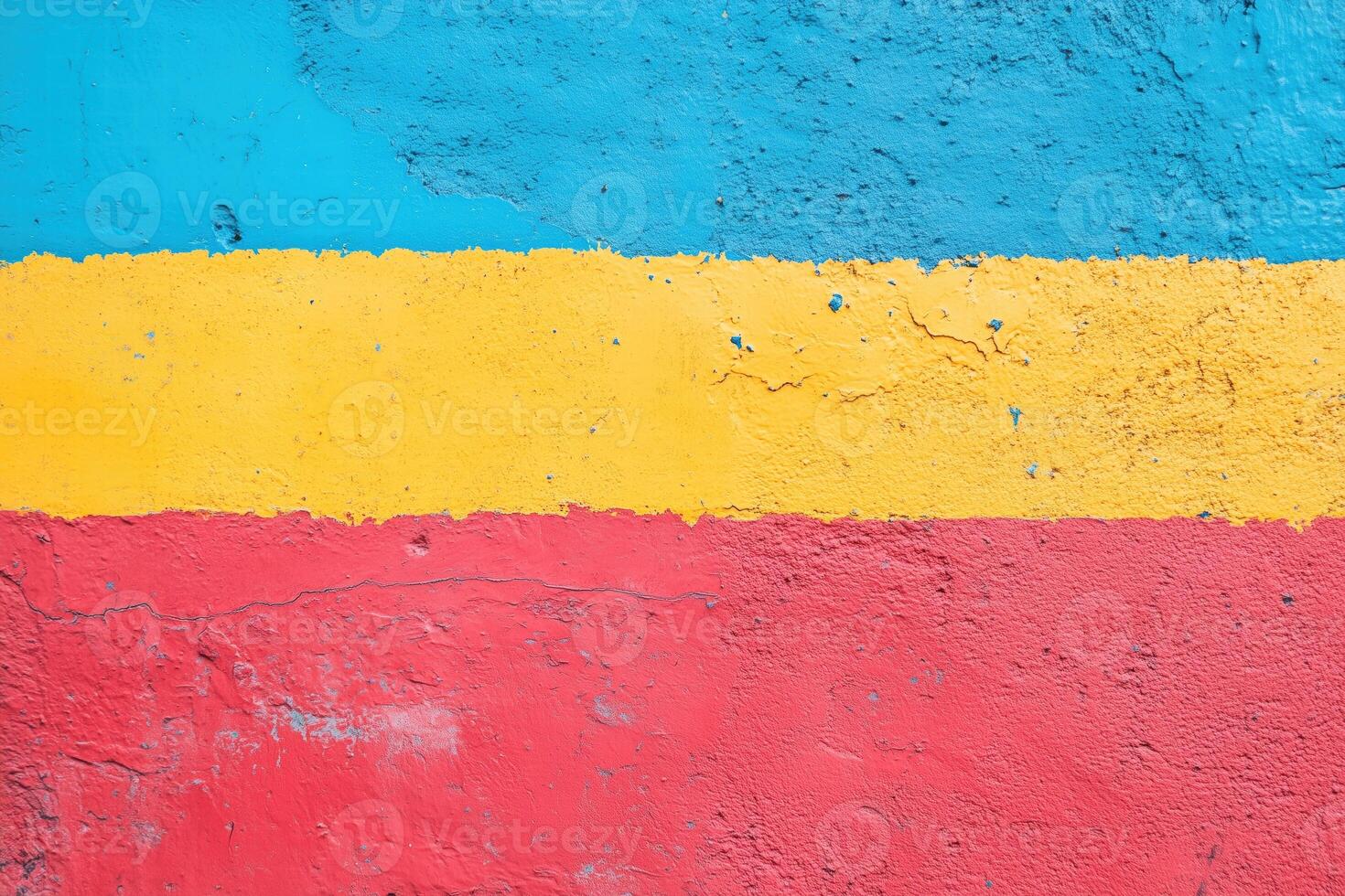 A vibrant wall painted with horizontal stripes of blue, yellow, and red. The texture shows some cracks and imperfections, adding character to the colorful design. photo