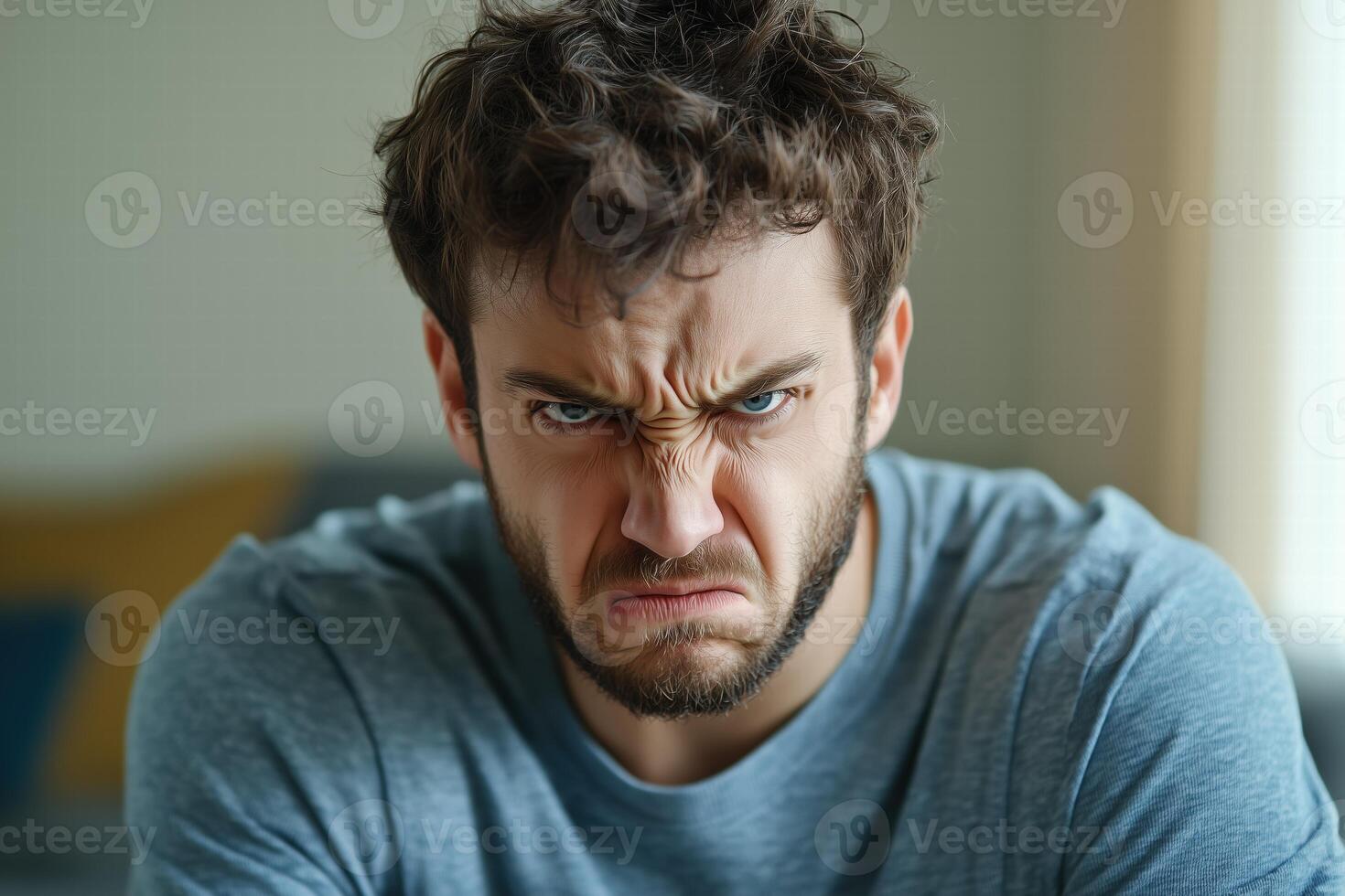 A man with a beard is looking at the camera photo