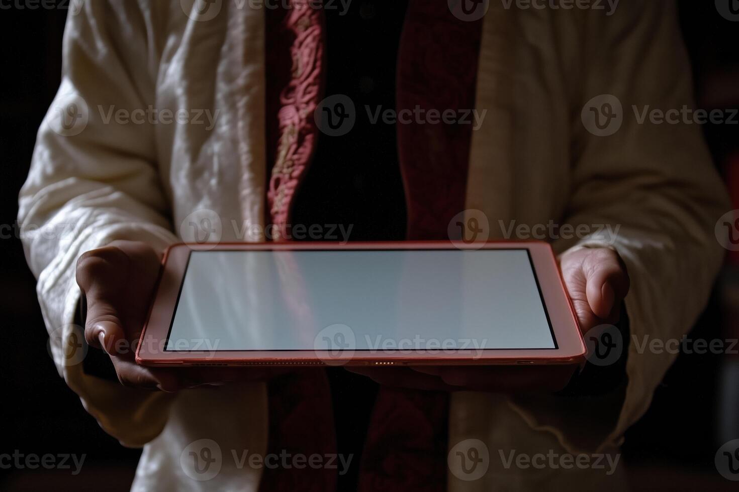 A person holding a tablet computer with a blank screen photo