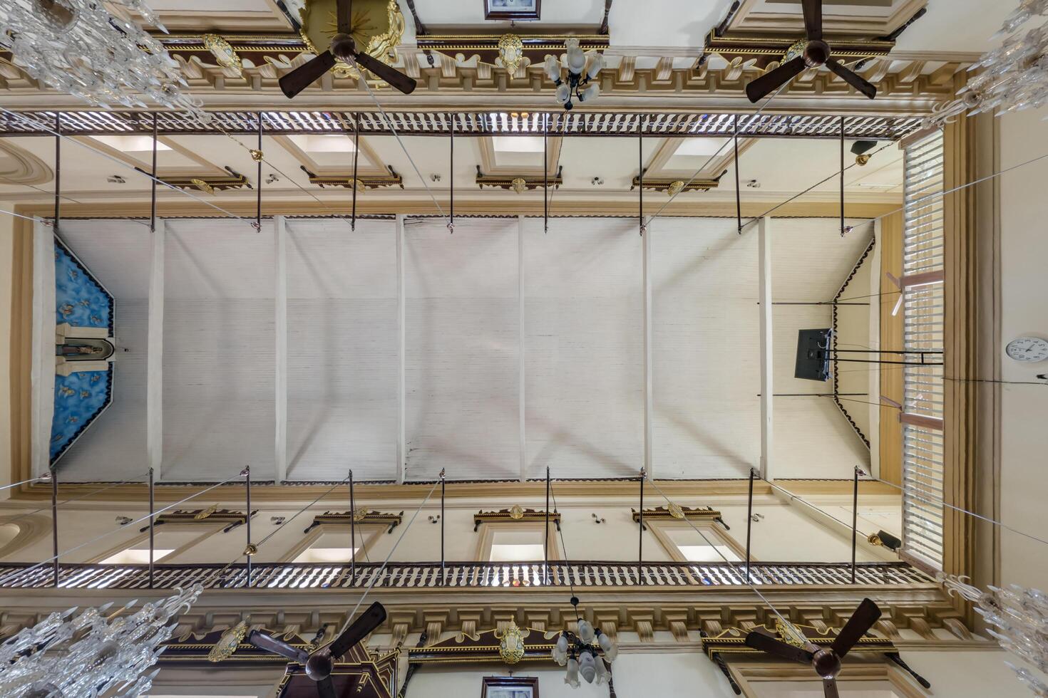 A view of a large building with a ceiling fan photo