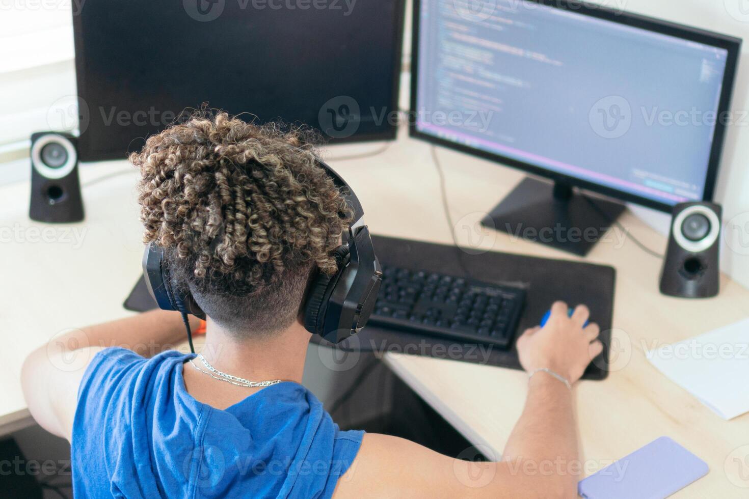 Male programmer working at his desk at home photo