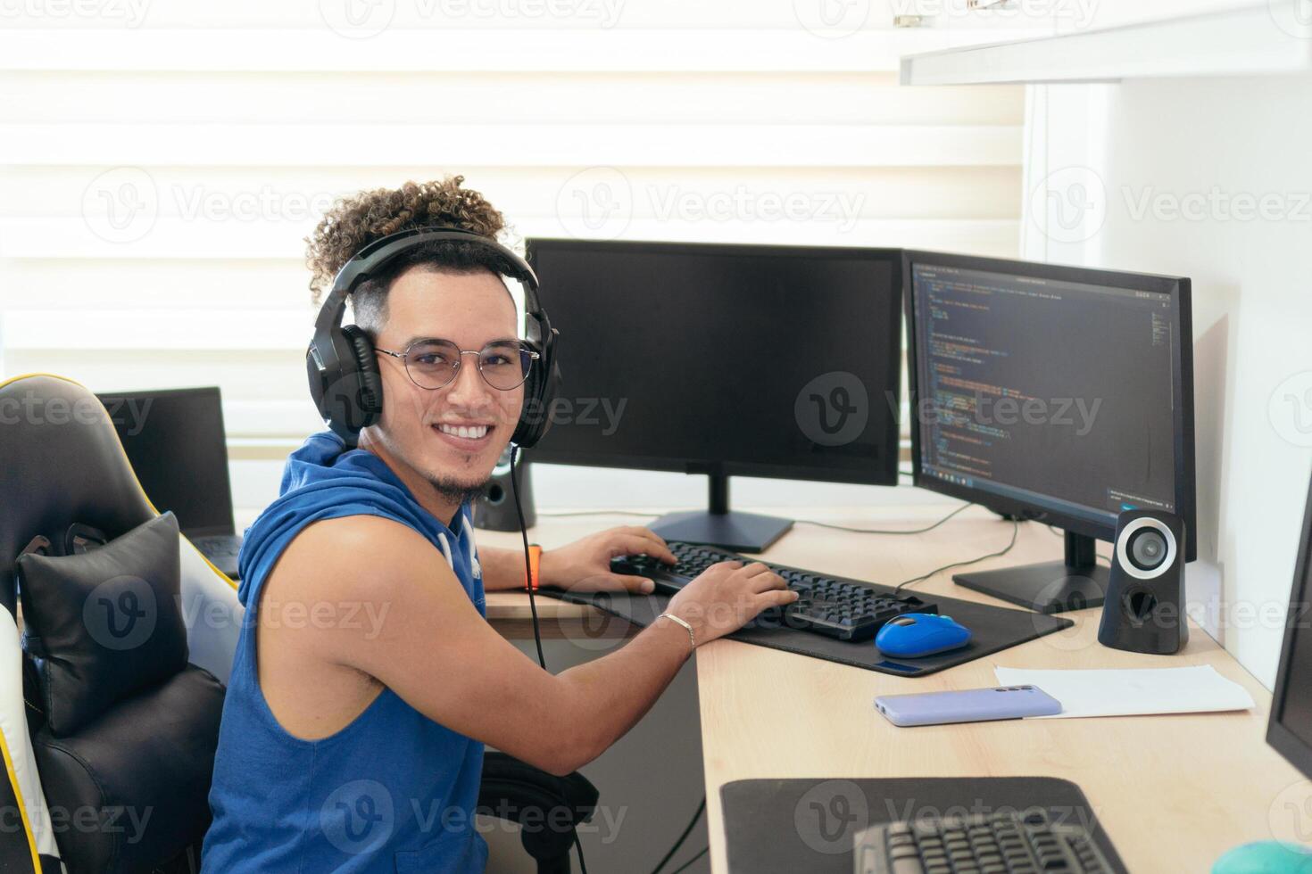 Young male programmer in casual clothes working on the computer at the table. photo