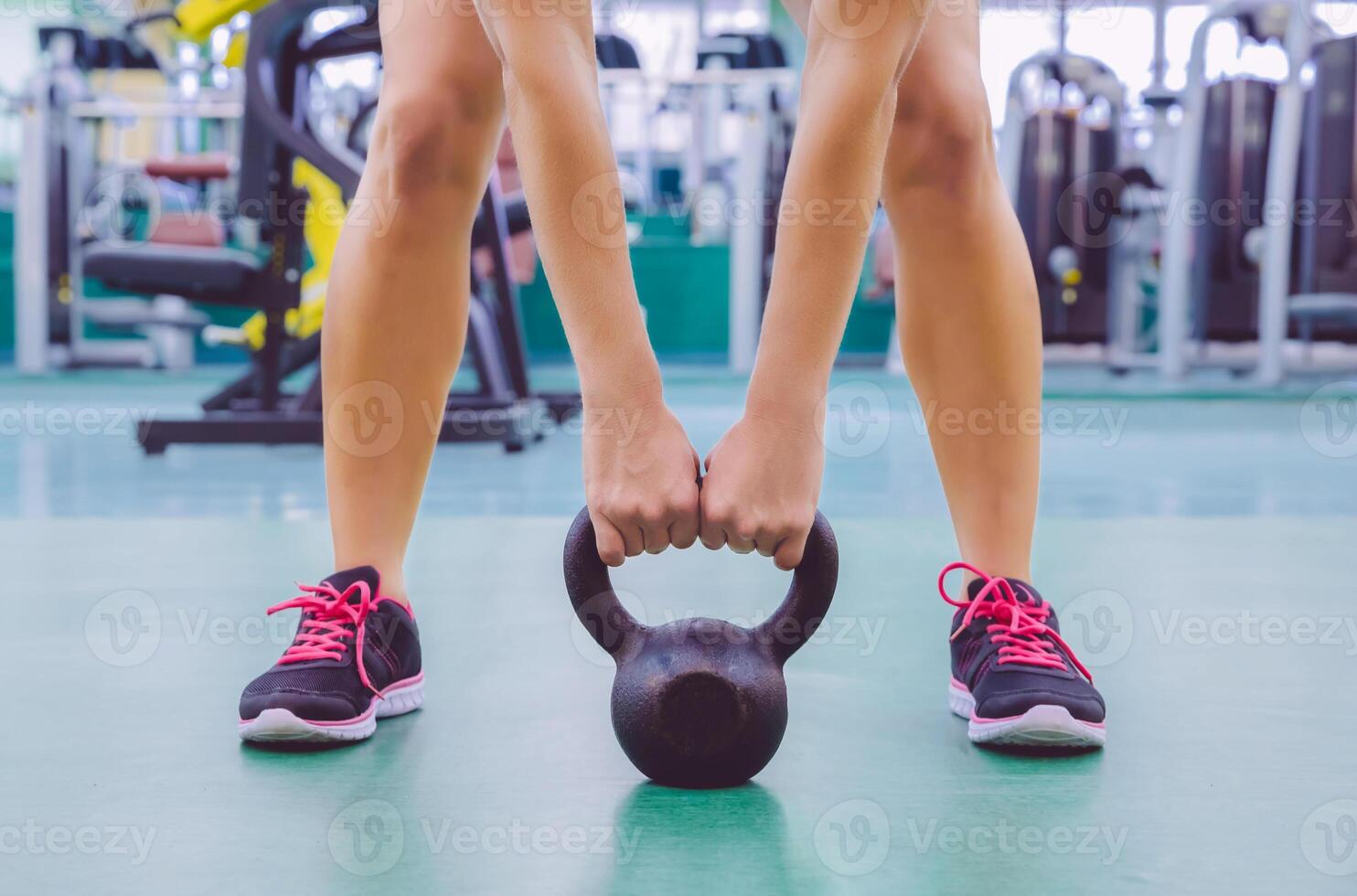 Woman ready to lift kettlebell in crossfit training photo